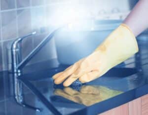 A woman deep cleaning her kitchen