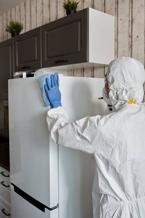 A cleaning lady service following SOPs while cleaning in a house in Rockville.